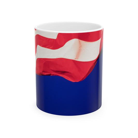 The Patriotic Colors of Red and White in the Stripes of the American Flag Wave Against a Deep Blue Sky, Perfect for an 11 or 15oz Mug.